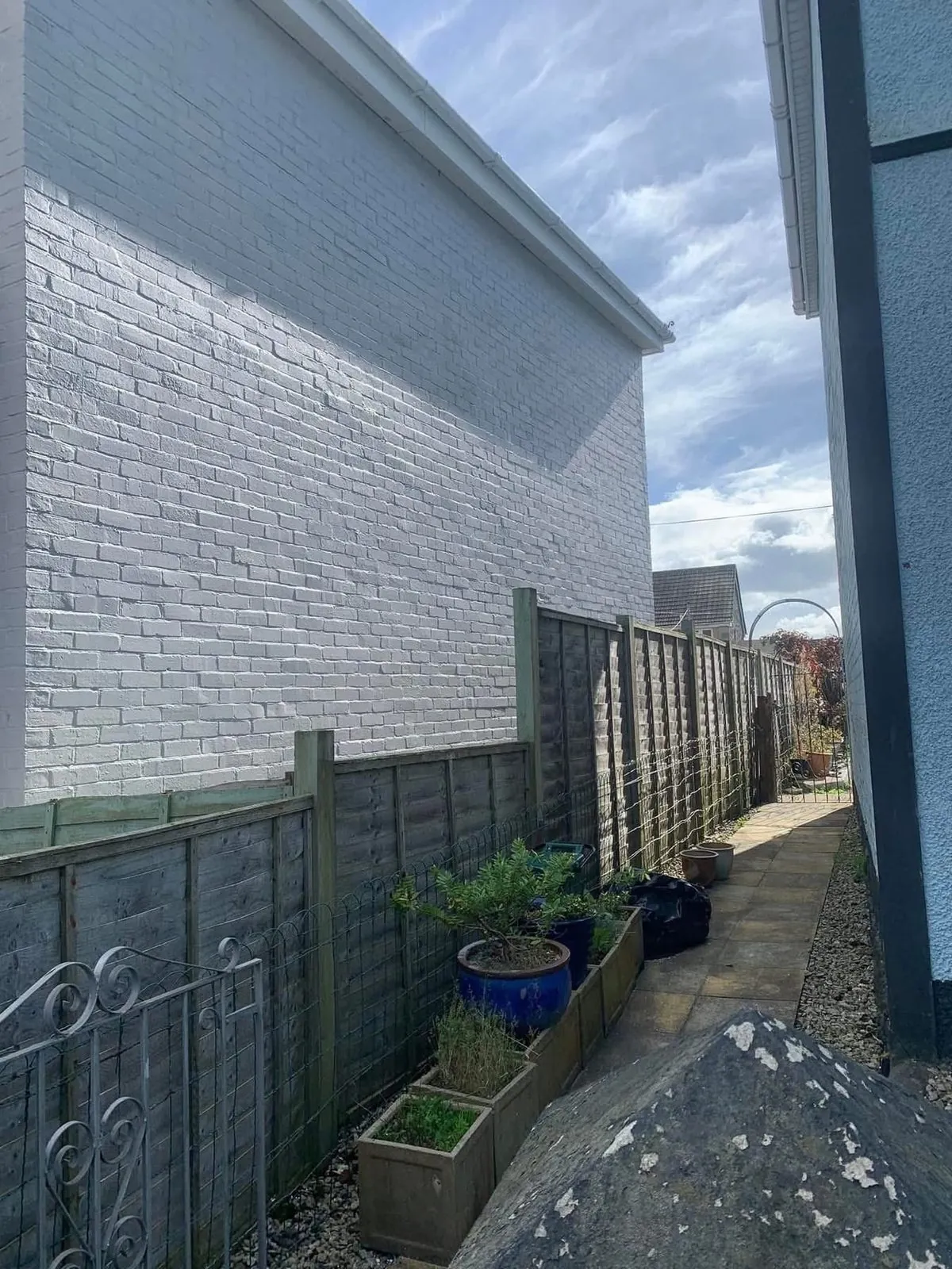 Freshly painted brick wall after preparation and masonry paint in Exeter